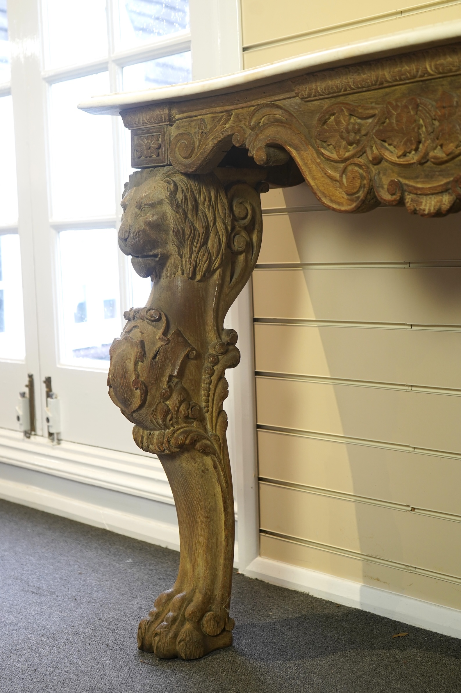 A 19th century Baroque style marble topped limed oak serpentine console table